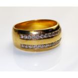 AN 18CT GOLD AND DIAMOND HALF ETERNITY RING Having two rows of round cut diamonds, channel set in