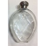 A VICTORIAN SILVER AND CUT GLASS PERFUME BOTTLE Having a stew cap with scrolled decoration and
