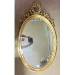 A FRENCH DESIGN OVAL MIRROR The giltwood frame with ribbon motif, together with carved pier mirror