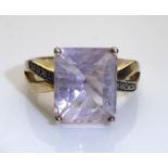A VINTAGE SILVER, DIAMOND AND AMETHYST DRESS RING Having a single square cut amethyst, held on a