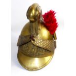 A 19TH CENTURY FRENCH BRASS FIREMAN'S HELMET Retaining the brass and leather chin strap and