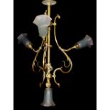 A 20TH CENTURY BRASS ELECTROLIER Of organic form with tulip glass shades.