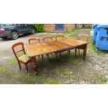 A 19TH CENTURY MAHOGANY EXTENDING DINING TABLE Having three extra leaves, raised on turned legs on