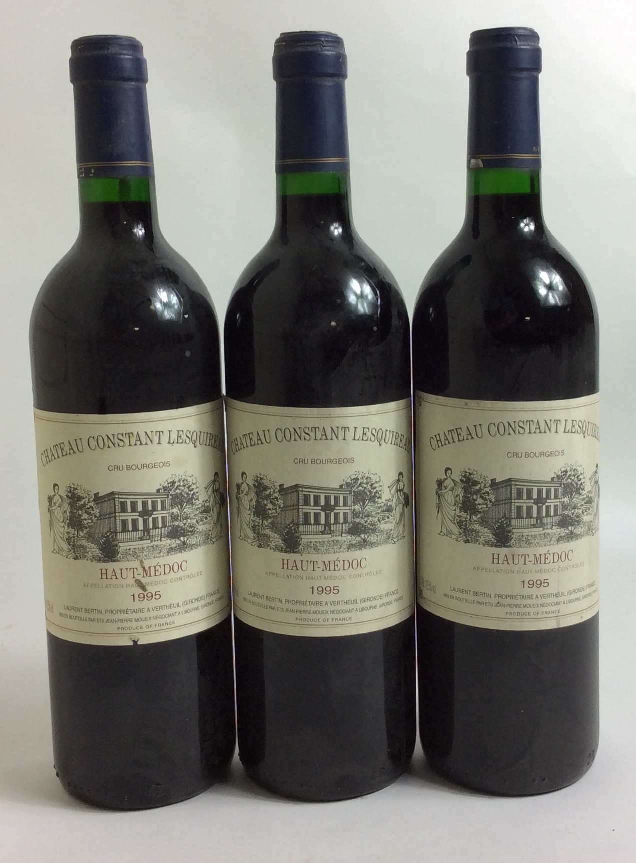 THREE BOTTLES OF VINTAGE WINE Château Constant Lesquireau, 1995, Haute-Médoc, bearing total blue