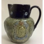 AN EARLY 20TH CENTURY DOULTON STONEWARE CORONATION JUG Dated 1911 and bearing portrait cartouches of