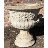 A SET OF THREE RECONSTITUTED STONE URNS Cast with cherubs, with shell handles. (60cm x 64cm)