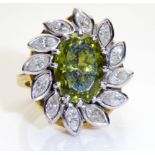 AN 18CT GOLD, DIAMOND AND TOURMALINE RING In stylized flower form with an arrangement of twelve