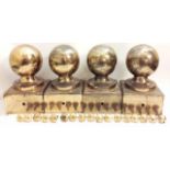 A SET OF FOUR 20TH CENTURY SPHERICAL BRASS MULE POSTS With square bases, retaining brass screws.