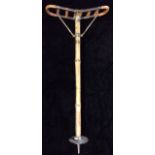 AN EARLY 20TH CENTURY BAMBOO SHOOTING STICK Brass bound with pierced folding seat and steel spike to