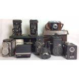A COLLECTION OF VINTAGE CAMERAS To include an Ensign Auto Cine camera, complete with leather carry