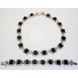 A VINTAGE MEXICAN SILVER AND ONYX NECKLACE AND MATCHING BRACELET Having oval cut onyx stones