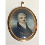 A 19TH CENTURY IVORY OVAL MINIATURE PORTRAIT Gentleman wearing a navy blue overcoat and white neck