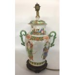 A CHINESE PORCELAIN LAMP Converted from a lidded vase decorated with figures and floral motifs. (h