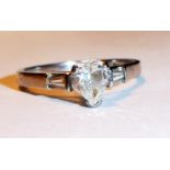 AN 18CT WHITE GOLD AND DIAMOND SOLITAIRE RING Having a pear cut diamond set between two tapering