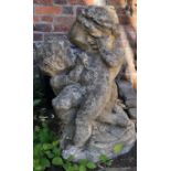 AN ANTIQUE CARVED STONE STATUE OF PLAYFUL PUTTI. (60cm)