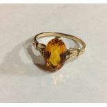A VINTAGE 9CT GOLD AND CITRINE RING Having a single oval cut faceted stone, held in a pierced good
