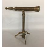 A VINTAGE BRASS TELESCOPE ON STAND The stand with collapsible triform base. (h 43cm)