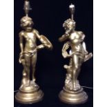 A PAIR OF 20TH CENTURY GILT PLASTER FIGURAL LAMPS Classical style figures of children holding a