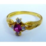 A VINTAGE 22CT GOLD AND GEM SET RING Having a single pink stone held in a daisy style setting,