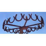 A 20TH CENTURY WROUGHT IRON LUCKY HORSESHOE CEILING LIGHT An arrangement of hand wrought iron