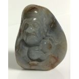 A 20TH CENTURY CHINESE CARVED JADE BRUSH STAND Finely carved with a portrait of an elder. (approx