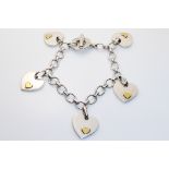 LINKS OF LONDON, AN 18CT GOLD AND SILVER CHARM BRACELET Having a monogrammed circular clasp, the