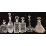 A COLLECTION OF VINTAGE CUT GLASS DECANTERS To include two square form spirit decanters, a ship's