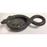 AN ANTIQUE BRONZE GRAND TOUR DESIGN OIL LAMP Featuring an entwined snake forming a shallow bowl. (