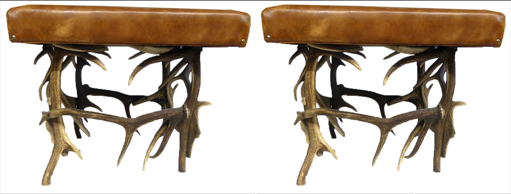 A PAIR OF TAN LEATHER STOOLS With antler bases. (61cm x 61cm x h 50cm)