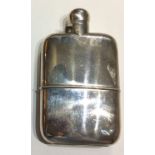 A LARGE EARLY 20TH CENTURY CURVED SILVER HIP FLASK With screw cap and removable cup to base,