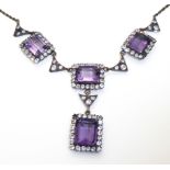 A VINTAGE YELLOW METAL, AMETHYST AND WHITE SAPPHIRE NECKLACE Having four baguette cut amethysts,
