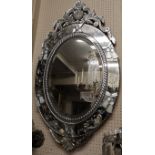 A VENETIAN OVAL ETCHED GLASS MIRROR With scrolling motifs, signed 'Glo'ziot'. (h 113cm x w 68cm)