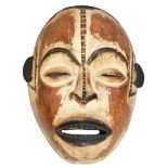 A 20TH CENTURY AFRICAN TRIBAL MASK Depicted as a stylized face. (h 27m x w 22cm x d 13cm)