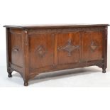 AN OAK JACOBEAN STYLE COFFER The panelled front with carved motifs. (w 108cm x h 56cm x d 48cm)