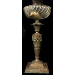 A VICTORIAN BRASS NEOCLASSICAL STYLE OIL LAMP Having a weather glass well and the tapering column,