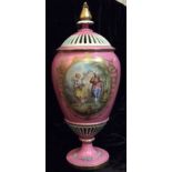 A 19TH CENTURY CONTINENTAL VASE AND COVER Having a pierced lid and hand painted cartouche