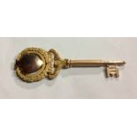 AN EARLY 20TH CENTURY 9CT GOLD PRESENTATION KEY Having shield form finial and laurel wreath scrolled