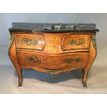 A 20TH CENTURY WALNUT BOMBÉ COMMODE With black marble top over an arrangement of three drawers,