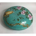A CHINESE PORCELAIN CIRCULAR BOX AND COVER Decorated with a songbird amongst flowering plants and