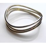LINKS OF LONDON, A MODERN SILVER BANGLE Having three narrow scrolled bands of silver. (approx 7cm)