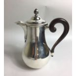 ROBERT LINZELER, A 20TH CENTURY SILVER TEAPOT Having a hinged lid over a shaped body with