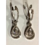 A PAIR OF 14CT WHITE METAL AND DIAMOND EARRINGS Pavé set diamonds forming consecutive pear form