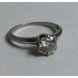 TIFFANY & CO., A DIAMOND AND PLATINUM SOLITAIRE RING Having a round cut diamond in a six prong clasp