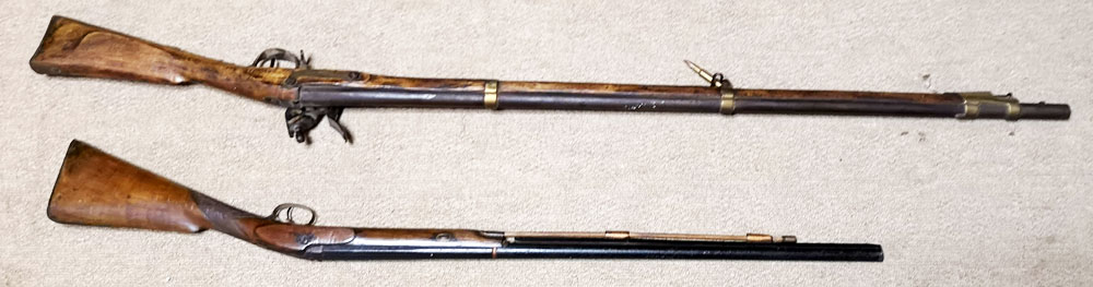 A LATE 19TH/EARLY 20TH CENTURY FLINTLOCK RIFLE With stored ramrod and brass mounts (possibly