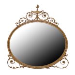 A LARGE 19TH CENTURY ROBERT ADAMS DESIGN GILTWOOD AND GESSO OVAL MIRROR Having a mercury plate,