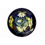 MOORCROFT, A 20TH CENTURY POTTERY DISH Having tube lined decoration of lily pads and flowers,