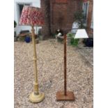 TWO 20TH CENTURY FLOOR STANDING LAMPS To include a cream painted lamp with fluted column, raised