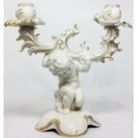 A 20TH CENTURY GERMAN PORCELAIN CANDELABRA Rococo style with a putti holding aloft twin branches,