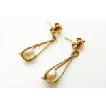 A PAIR OF VINTAGE 9CT GOLD AND PEARL EARRINGS Each having a single pearl held in a spiral wirework