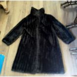 A VINTAGE DARK BROWN MINK FUR COAT With a sweeping collar, swing shaped and satin lined, bearing